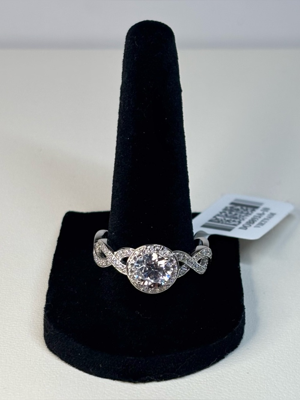 Platinum-plated sterling silver ring featuring round CZ stone with halo